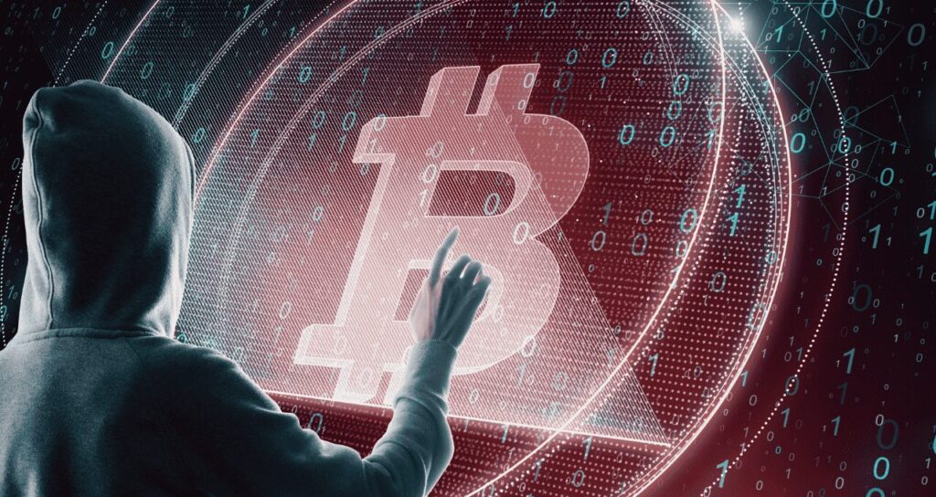 Hooded person interacting with Bitcoin symbol in digital environment, suggesting hacker invasion or crypto cyber threat.