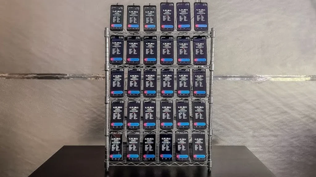 Rack with dozens of smartphones simultaneously operating cryptocurrency mining applications, indicating a mobile mining farm.